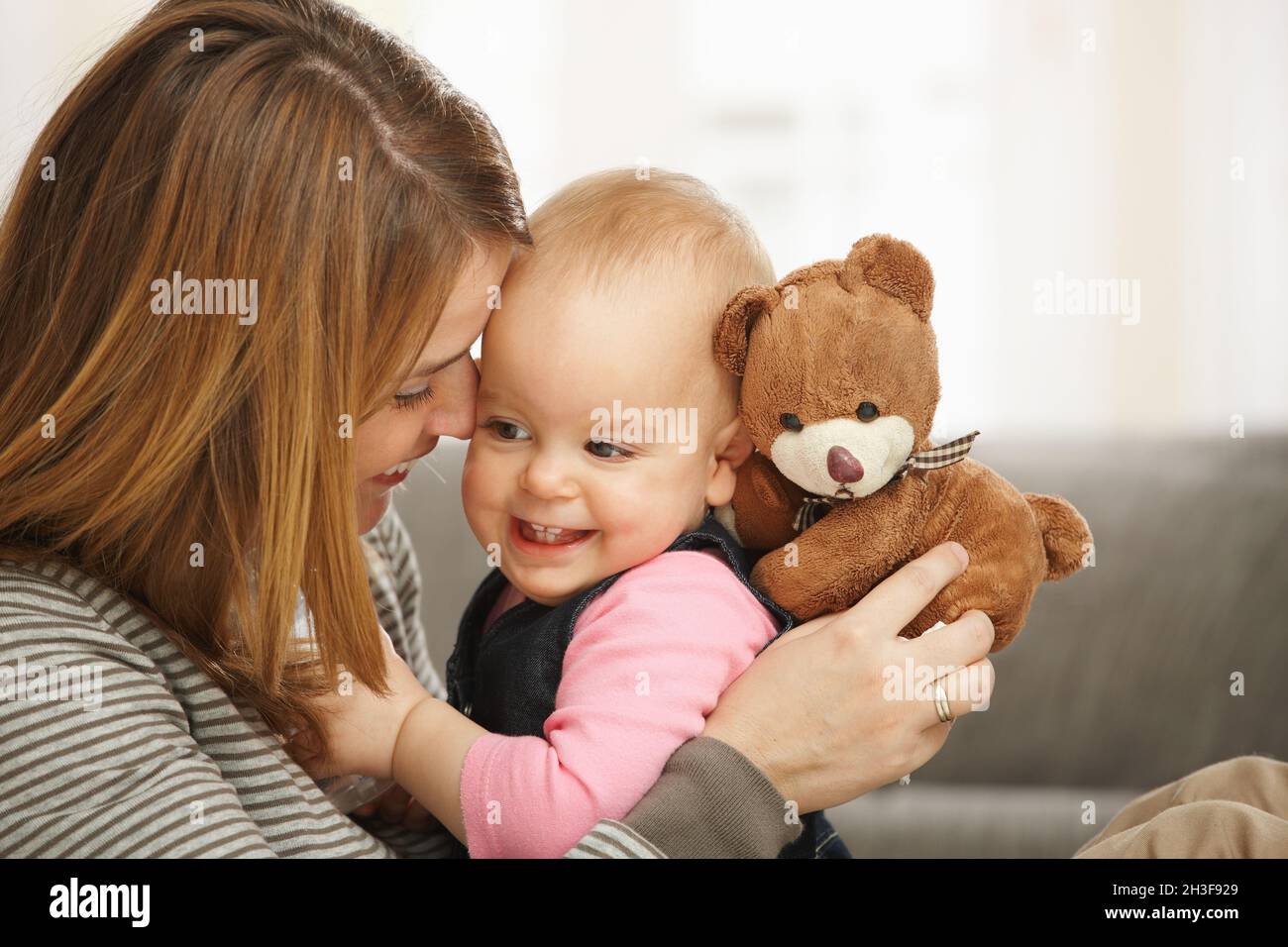 Happy mum and baby with teddy bear Stock Photo - Alamy