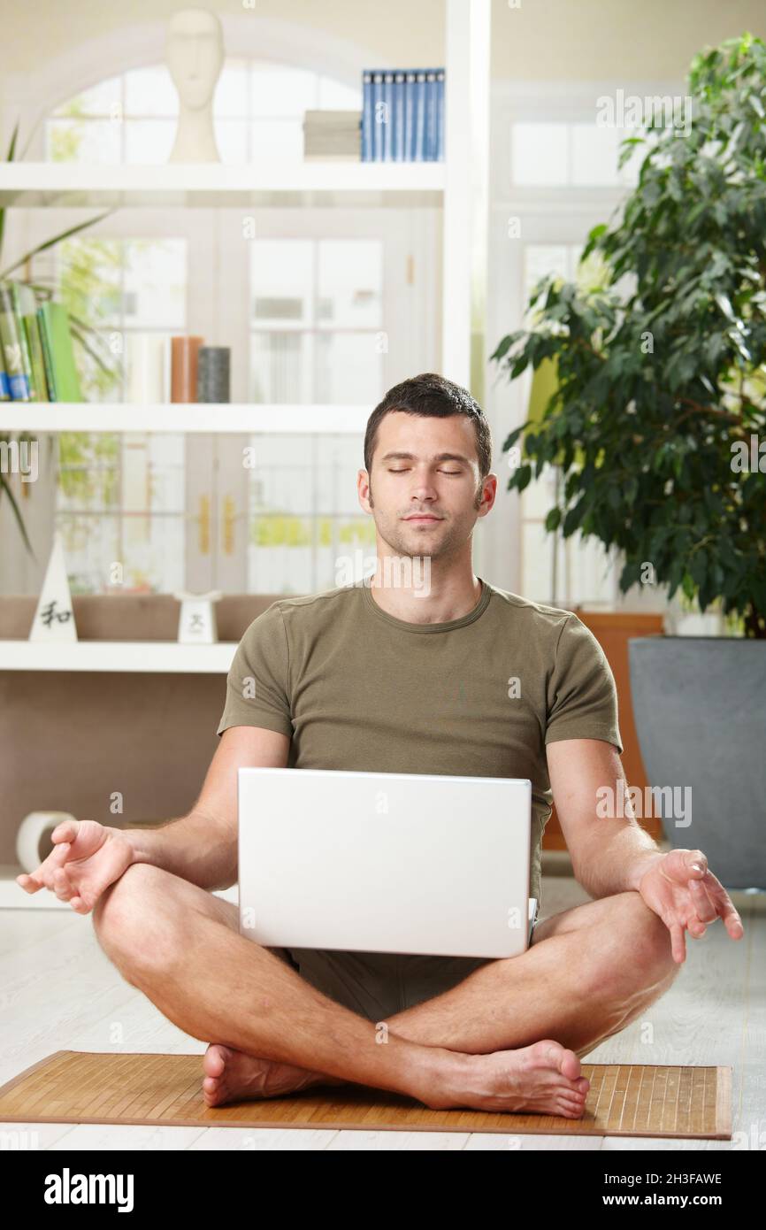Meditation with laptop computer Stock Photo - Alamy