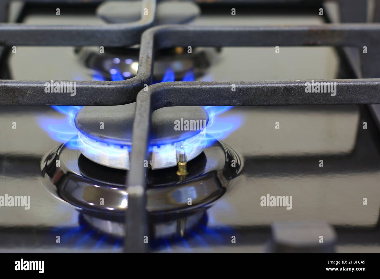 Blue flames of gas burning from a kitchen gas stove. Gas cooker with