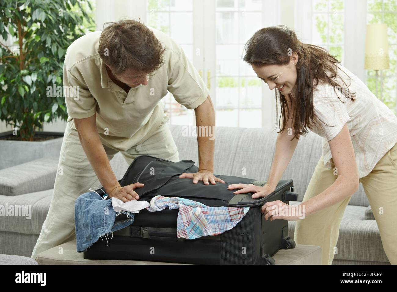 Closing suitcase Stock Photo Alamy