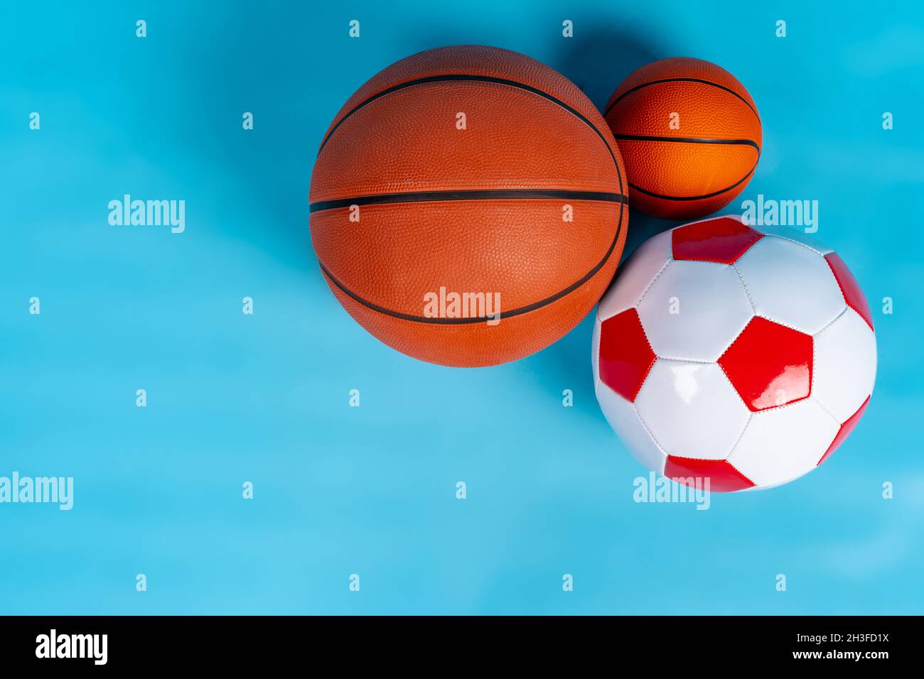 Basketball and soccer balls on a blue background Stock Photo Alamy