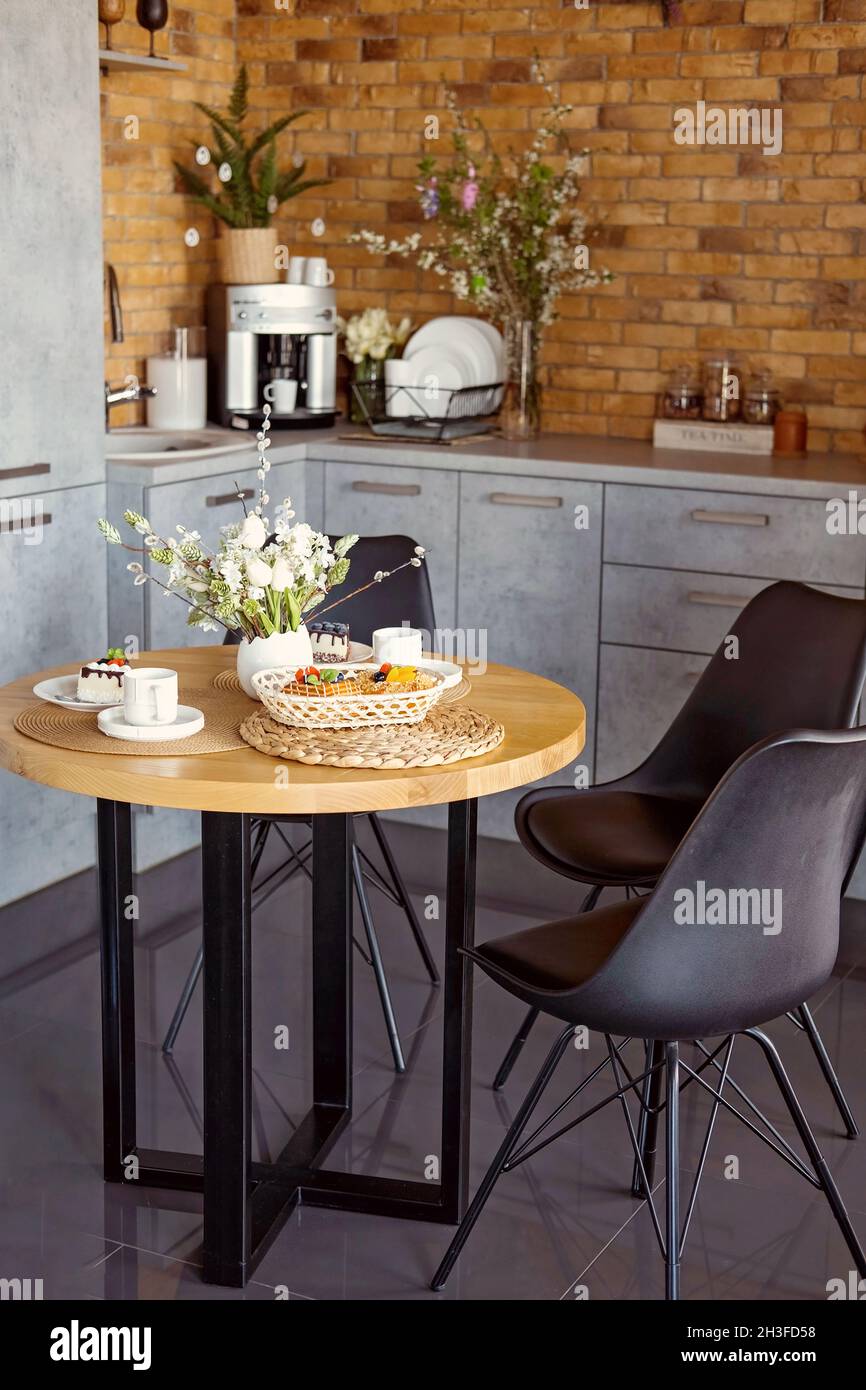 Easter table with spring flowers in a modern kitchen Stock Photo