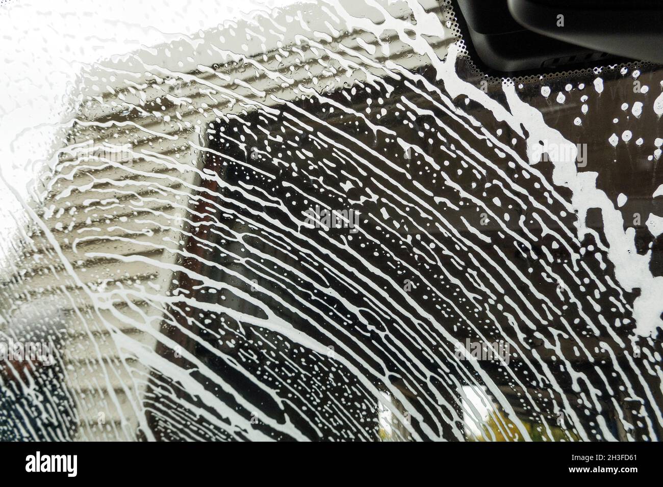 Winchester, Hampshire, UK. 2021. Drivers eye view of soap suds and