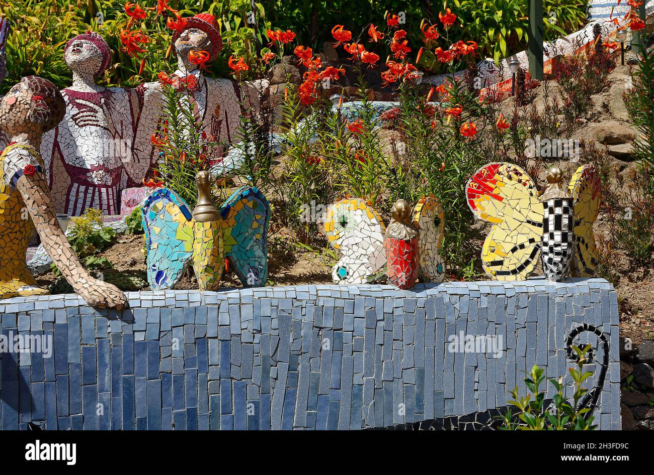 garden sculptures, mosaic tile pieces, butterflies, people, flowers