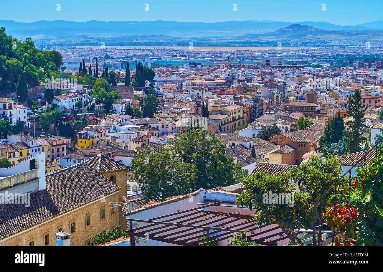 The old tile roofs of Granada and the scenery of Sierra Nevada from the hill of Albaicin neighborhood, Granada, Spain Stock Photo