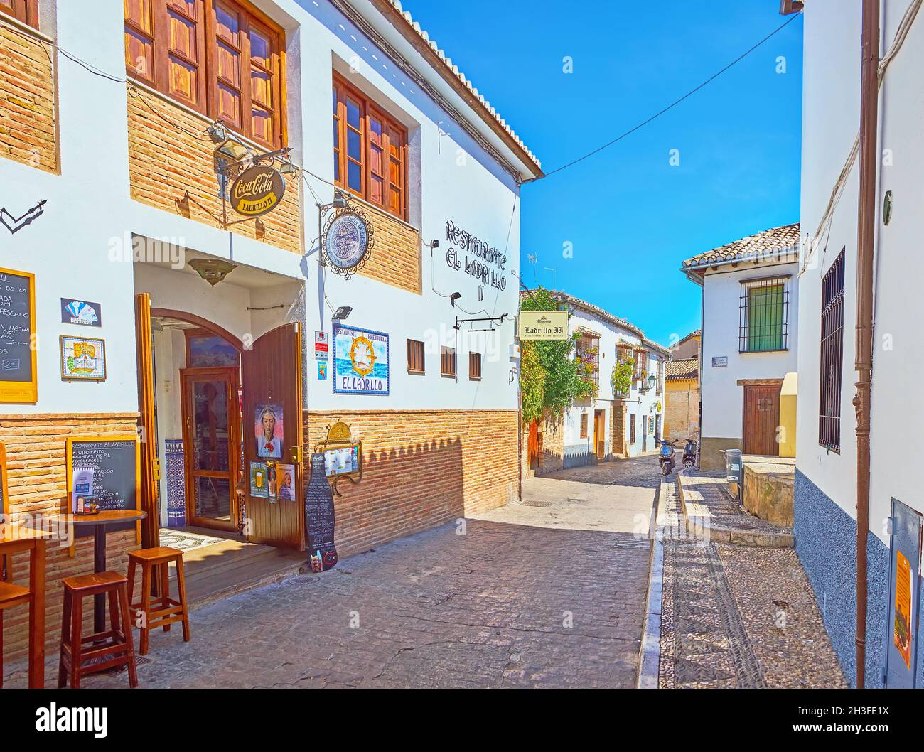 GRANADA, SPAIN - SEPTEMBER 27, 2019: Historic Panaderos street of Albaicin with scenic cafes, bars and restaurants, on September 27 in Granada Stock Photo