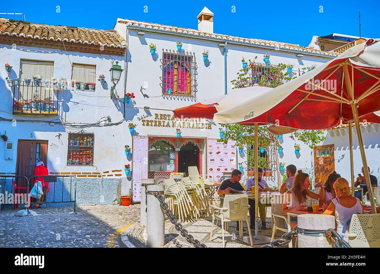 GRANADA, SPAIN - SEPTEMBER 27, 2019: The small outdoor terrace of the restaurant, located in historic house of Espalda de San Nicolas street, on Septe Stock Photo