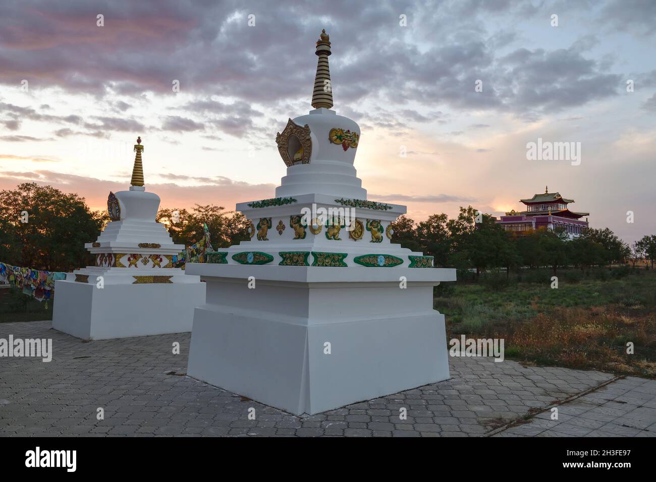 Stupas at the Syakyusn-syume Buddhist temple against the backdrop of a September cloudy sunset. Environs of Elista. Republic of Kalmykia, Russia Stock Photo