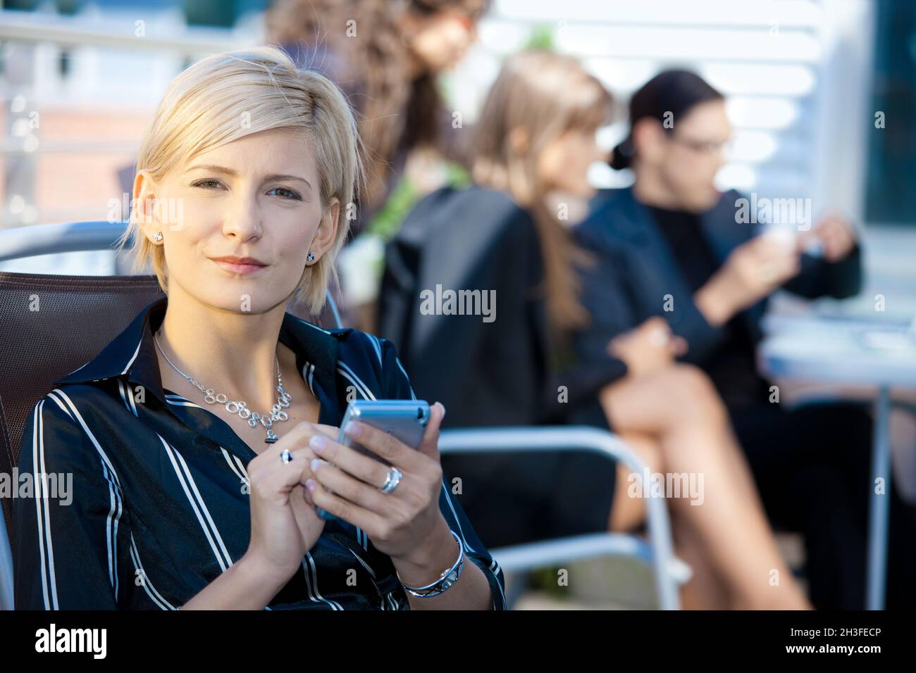 Businesswoman using smart phone Stock Photo