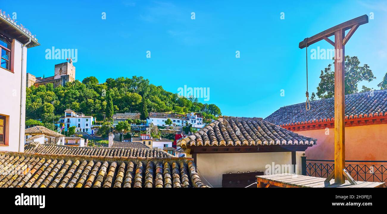 The scenic upper terrace of Inquisition Museum with gallows, observing old tile roofs of Albaicin and tower of Alhambra, Granada, Spain Stock Photo