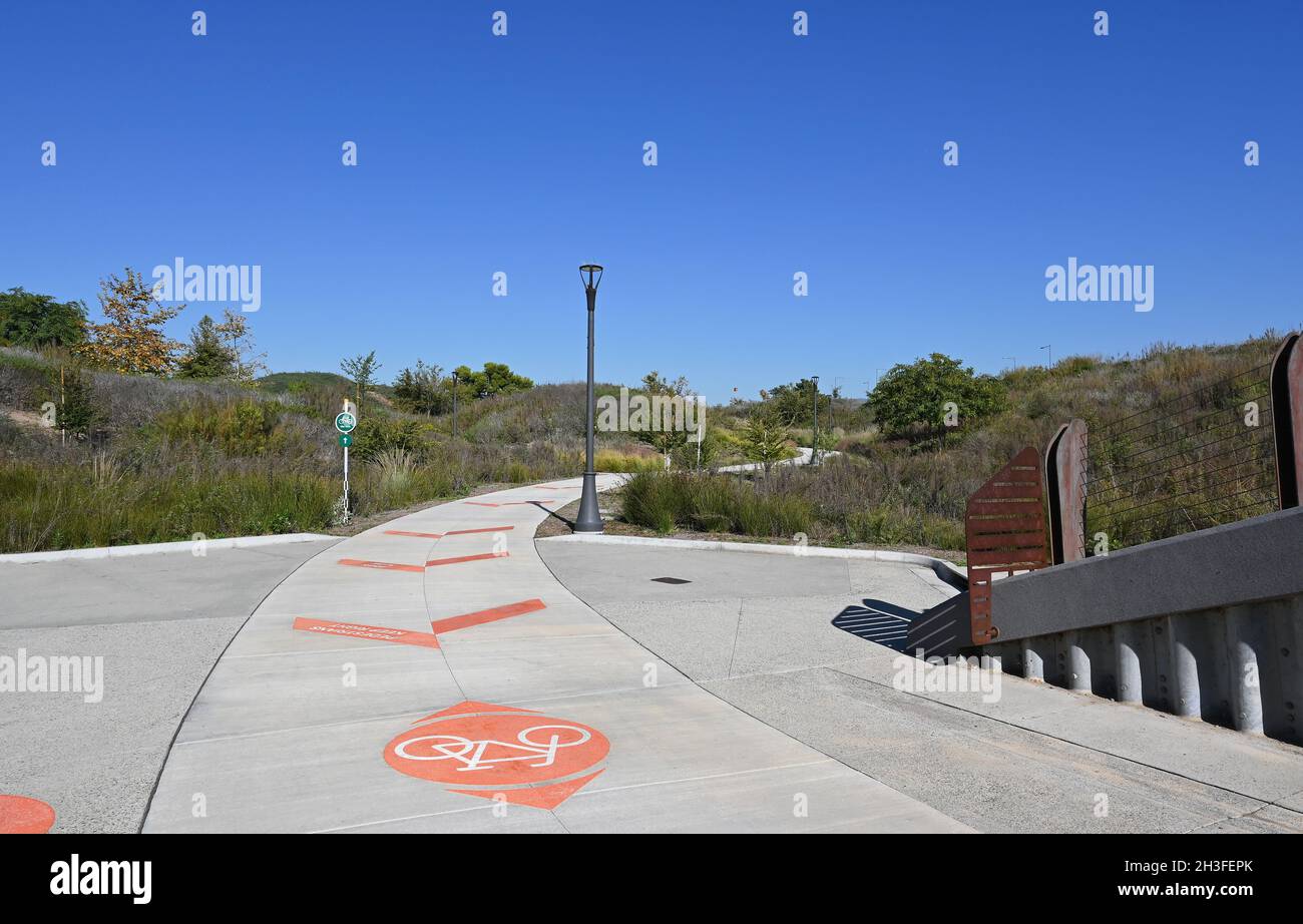 IRVINE, CALIFORNIA - 27 OCT 2021: Signs on the pavement in the Great Park Trails, a 1.5 mile walking and biking space throughout the Upper Bee and Bos Stock Photo