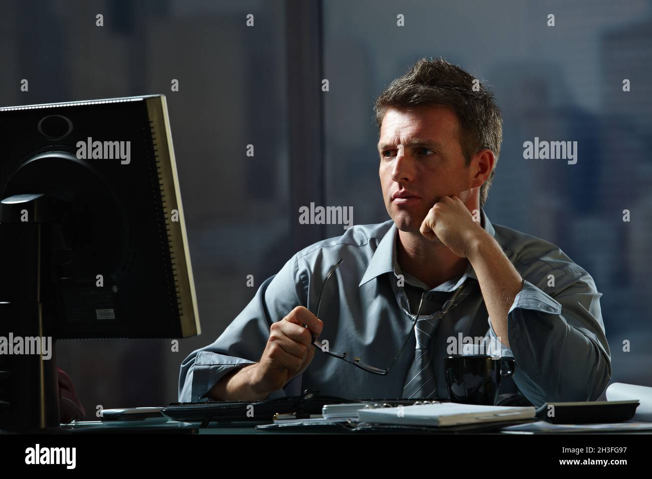 Businessman working late in office Stock Photo