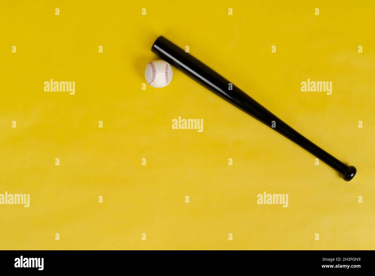Baseball bat and ball on bright yellow background Stock Photo Alamy