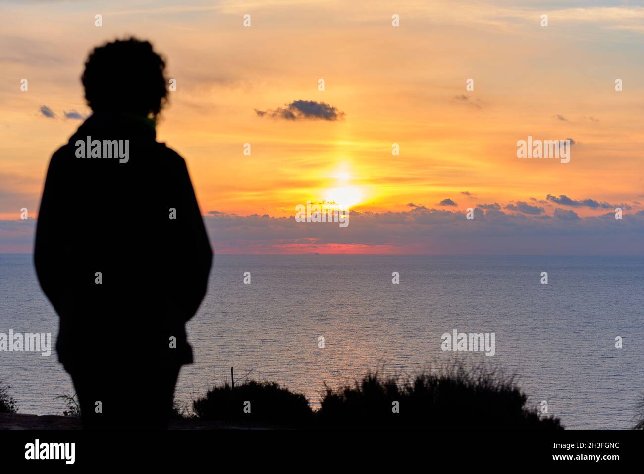 Woman standing watching sea hi-res stock photography and images - Alamy