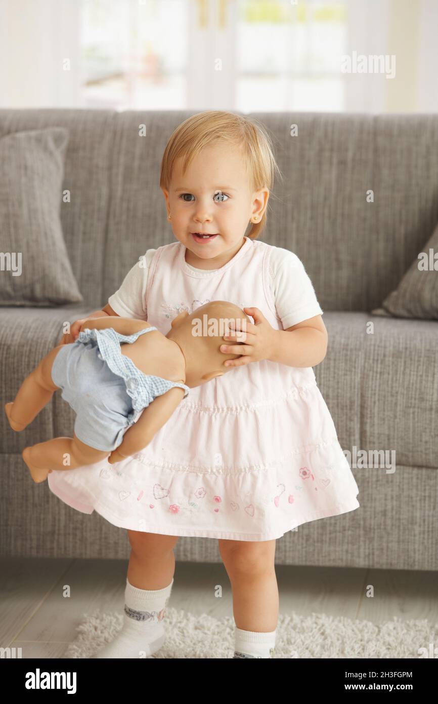 Little girl with dolly Stock Photo Alamy