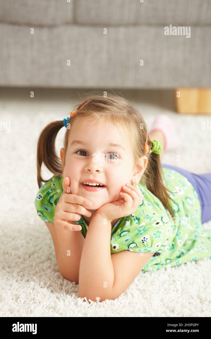 Portrait of happy little girl at home Stock Photo Alamy