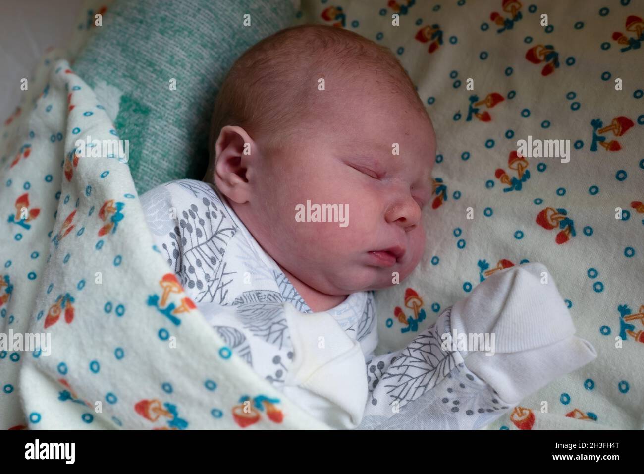Adorable caucasian newborn baby sleeping in bed Stock Photo Alamy