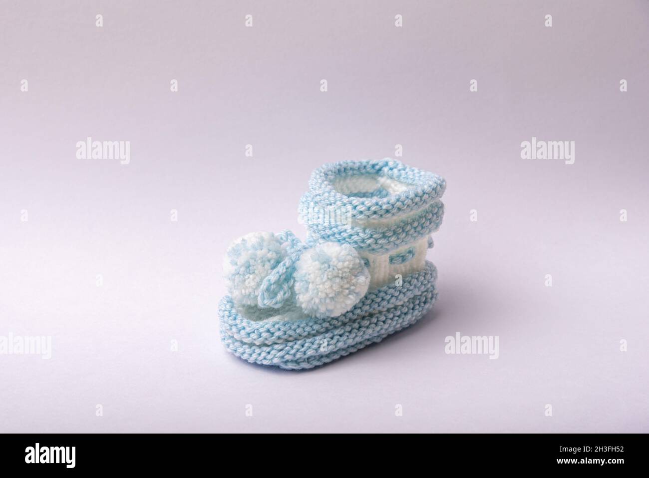 homemade knitted shoes for newborn boys on white background Stock Photo