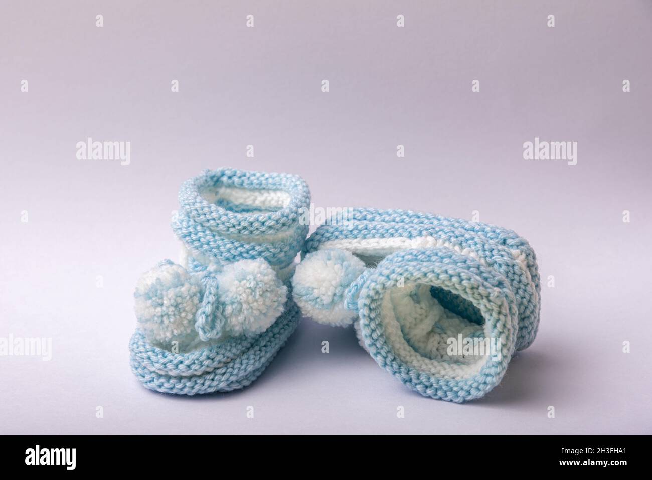 homemade knitted shoes for newborn boys on white background Stock Photo