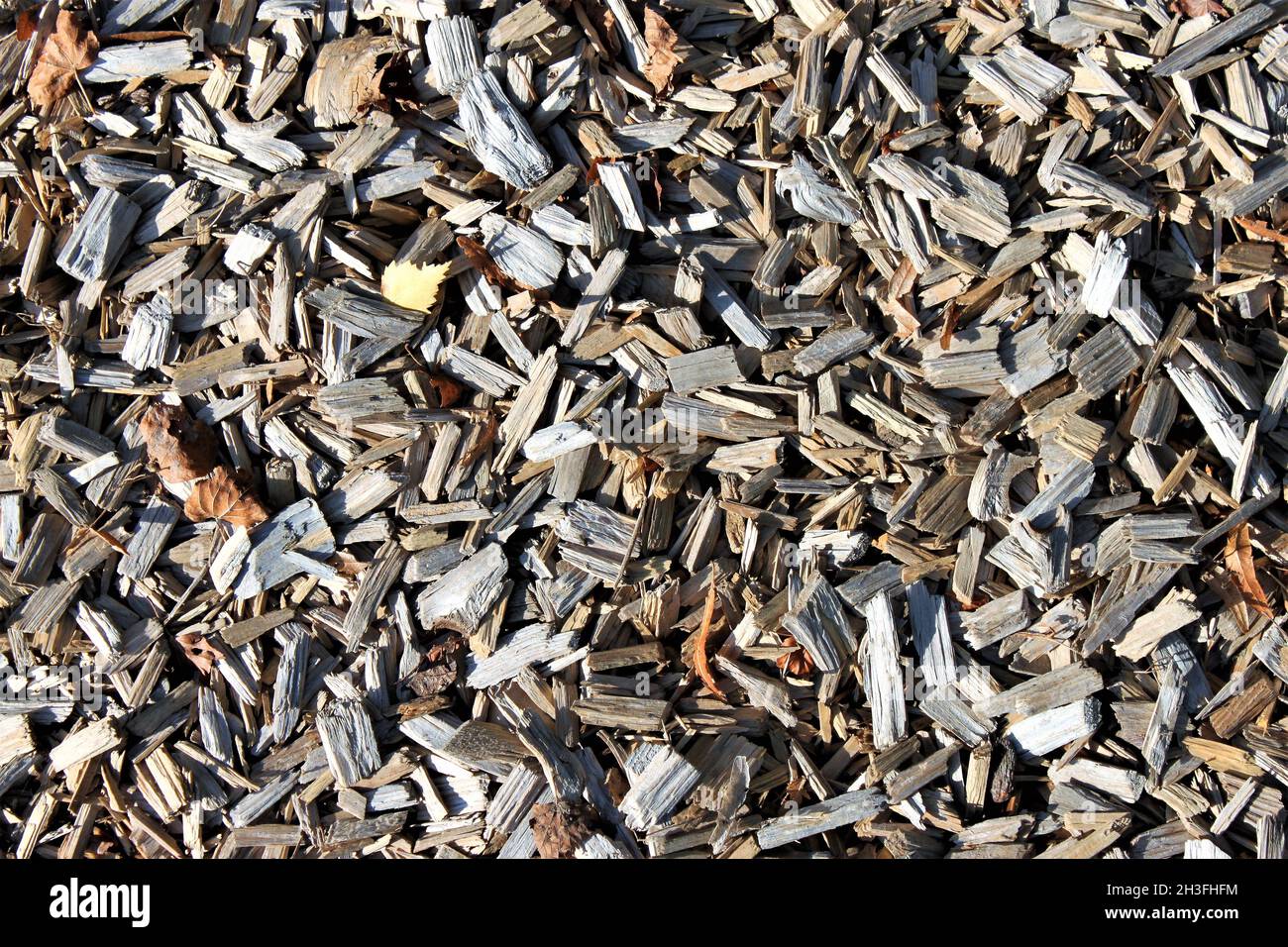 a pile of wood chips unsorted outside on a playground Stock Photo