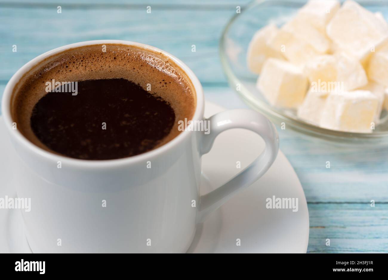 Freshly brewed coffee in a white Turkish mug close-up. Stock Photo