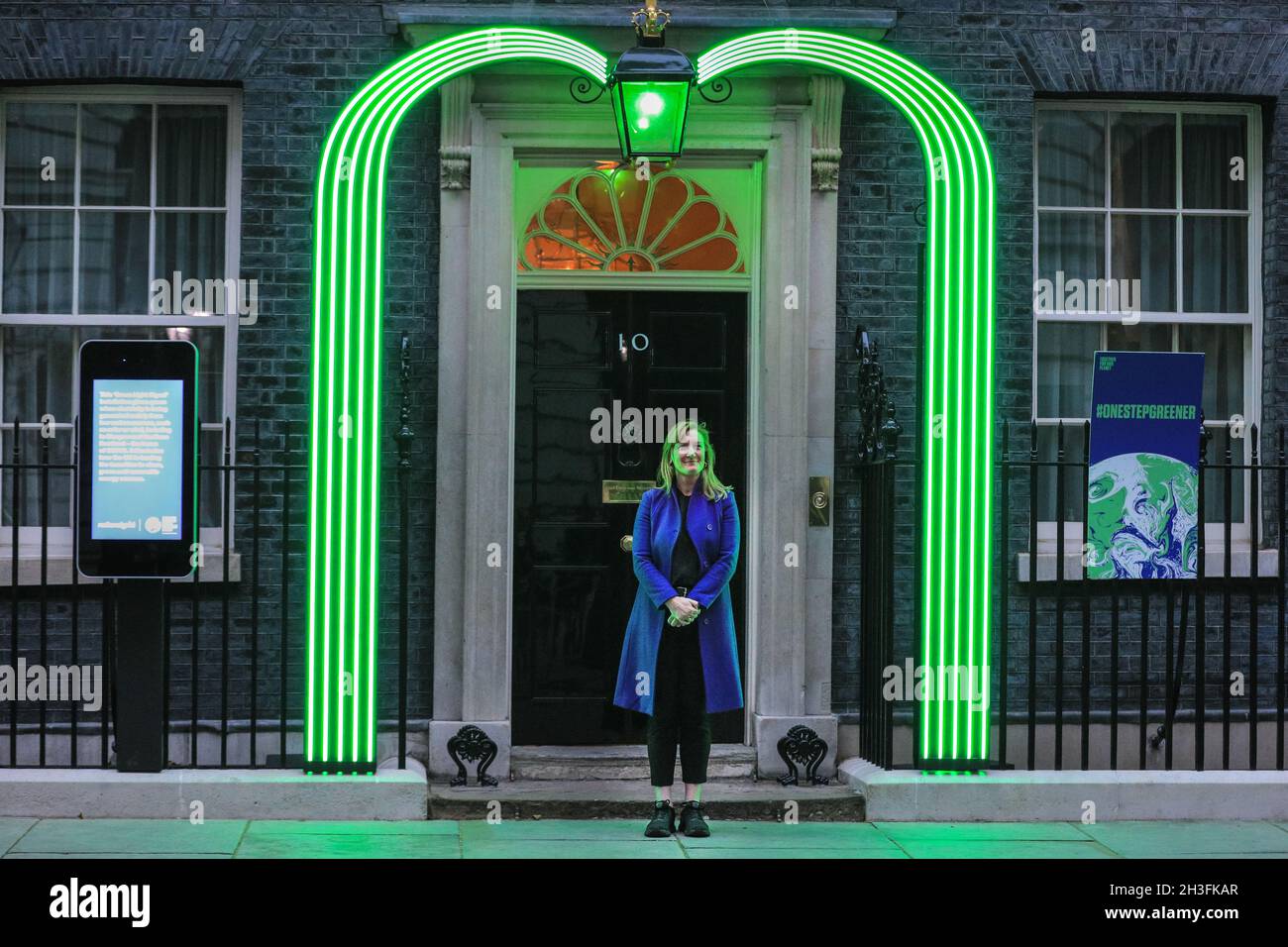 Downing Street, London, UK. 28th Oct, 2021. Allegra Stratton, spokesperson for COP26 Summit in Glasgow and President Alok Sharma, poses under the new green Downing Street light installation for the COP 26 Summit which was revealed this evening. Credit: Imageplotter/Alamy Live News Stock Photo