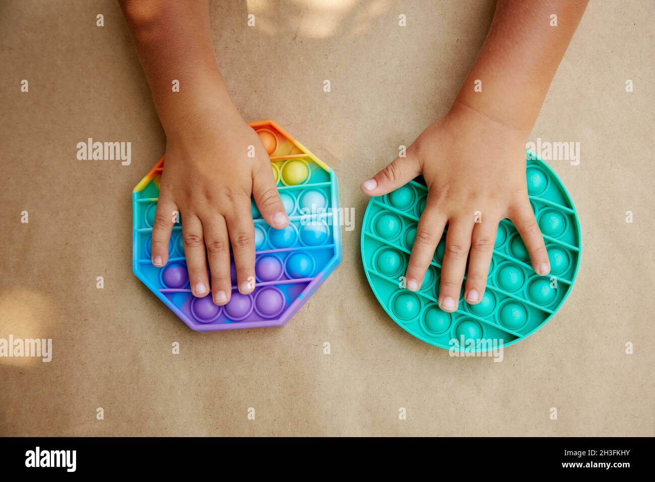 Colorful antistress sensory toy fidget push pop it in toddler's hands