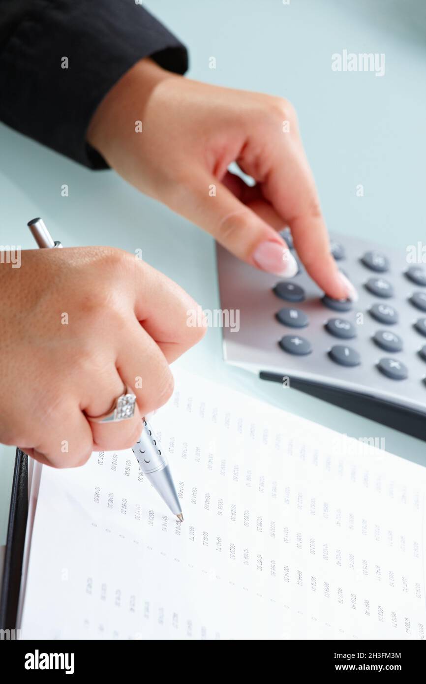 Female hands using calculator Stock Photo