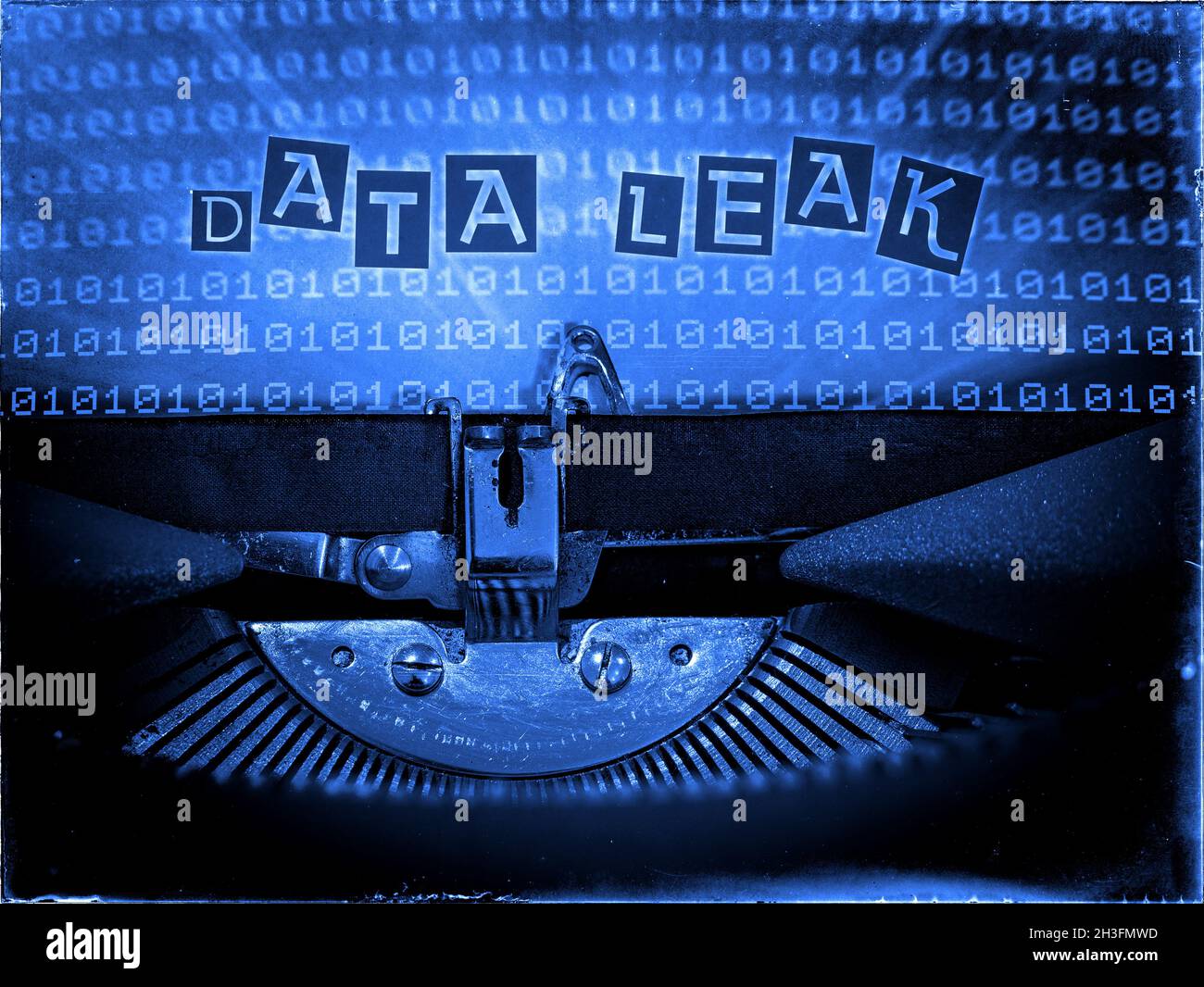 Data Leak displayed on a Mechanical Typewriter with a Binary code background and a Blue tone, Vintage distorted look, Ransom note typography Stock Photo