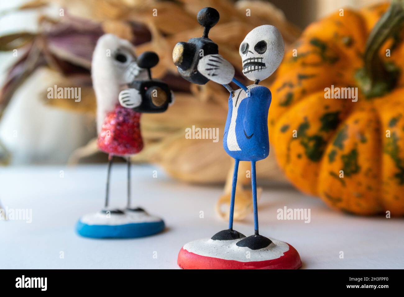 Sugar Skull Figurines Taking Autumn Decoration Photos, USA, 2021 Stock Photo
