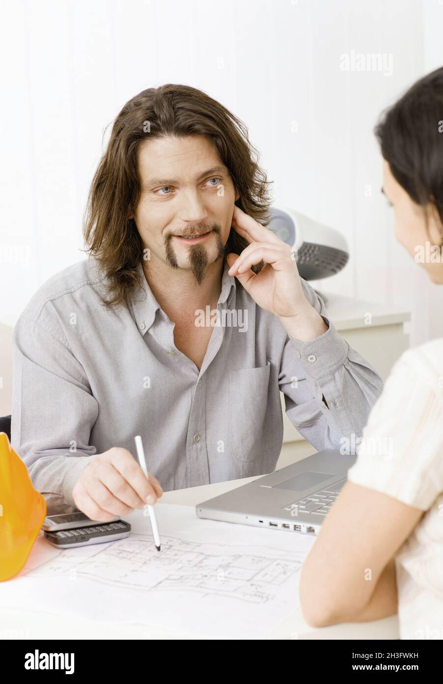 Architect showing plans Stock Photo - Alamy