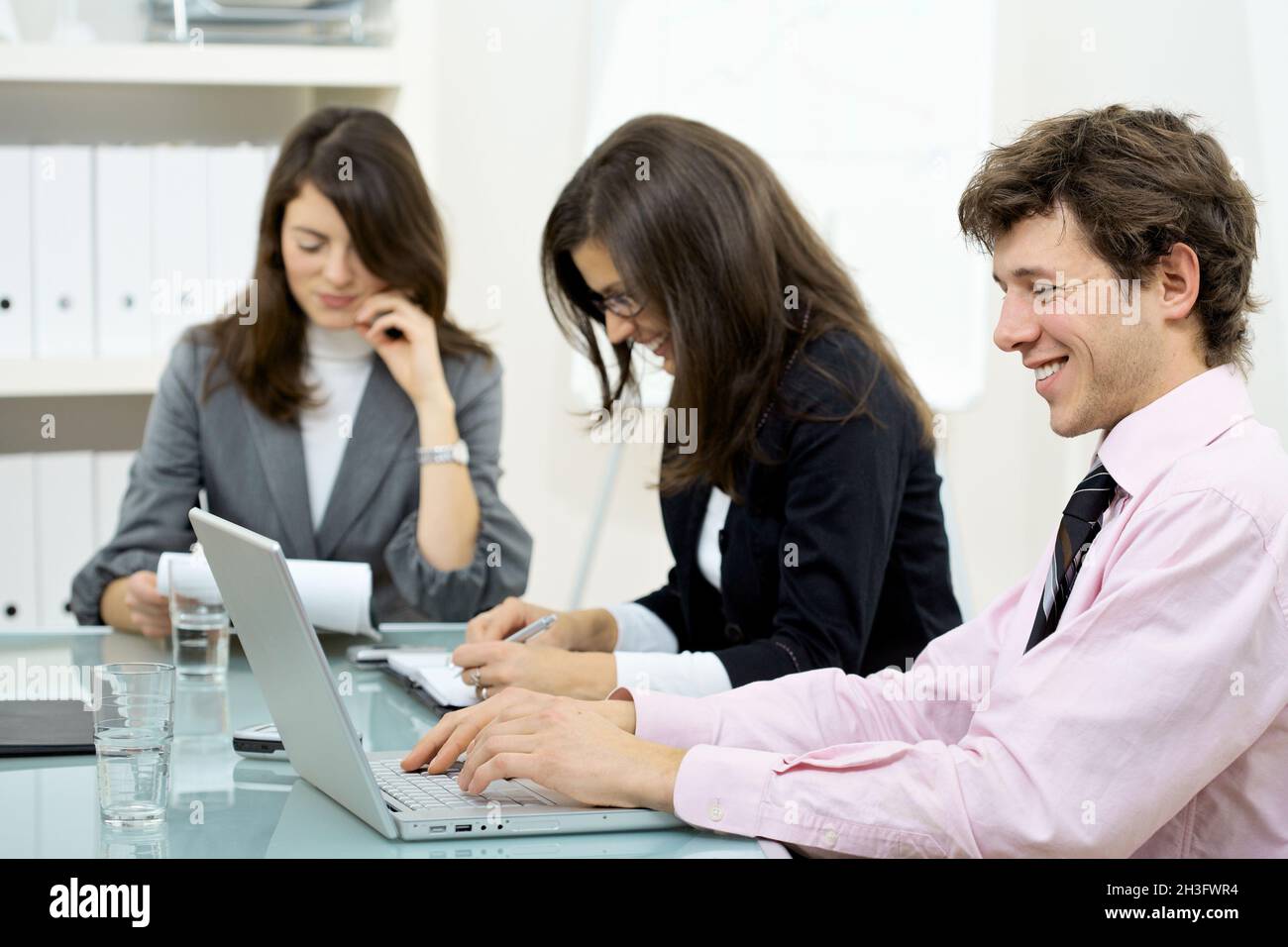 Collaborating business team typing hi-res stock photography and images ...