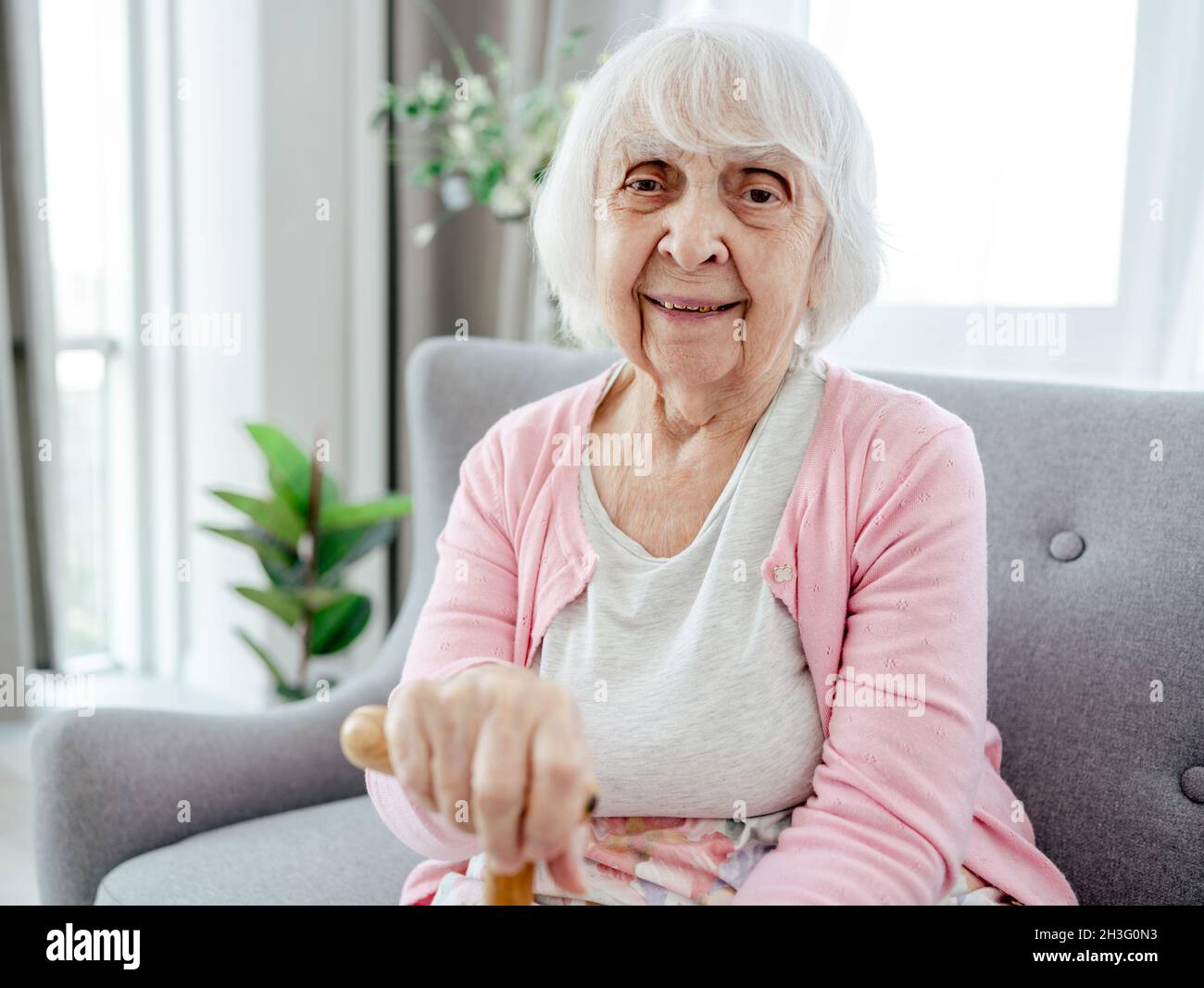 Senior woman with walking stick Stock Photo - Alamy