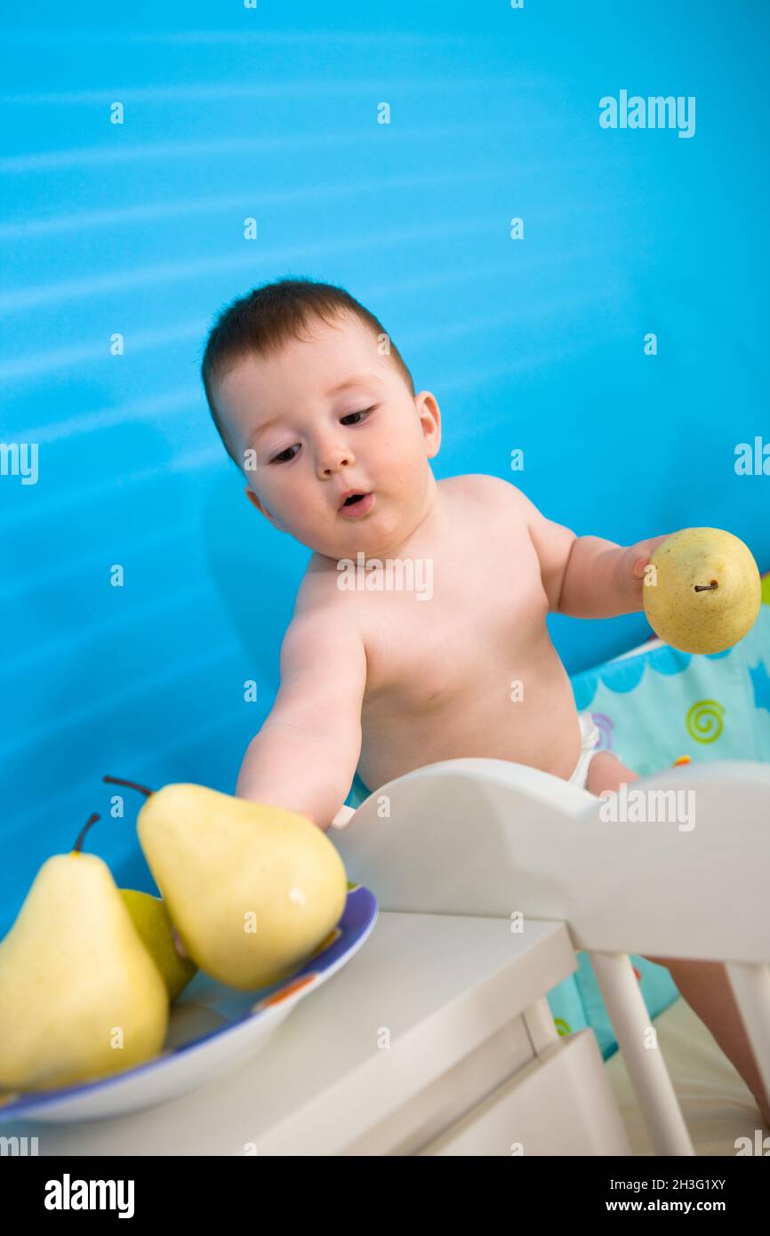 Baby eating fruits Stock Photo - Alamy