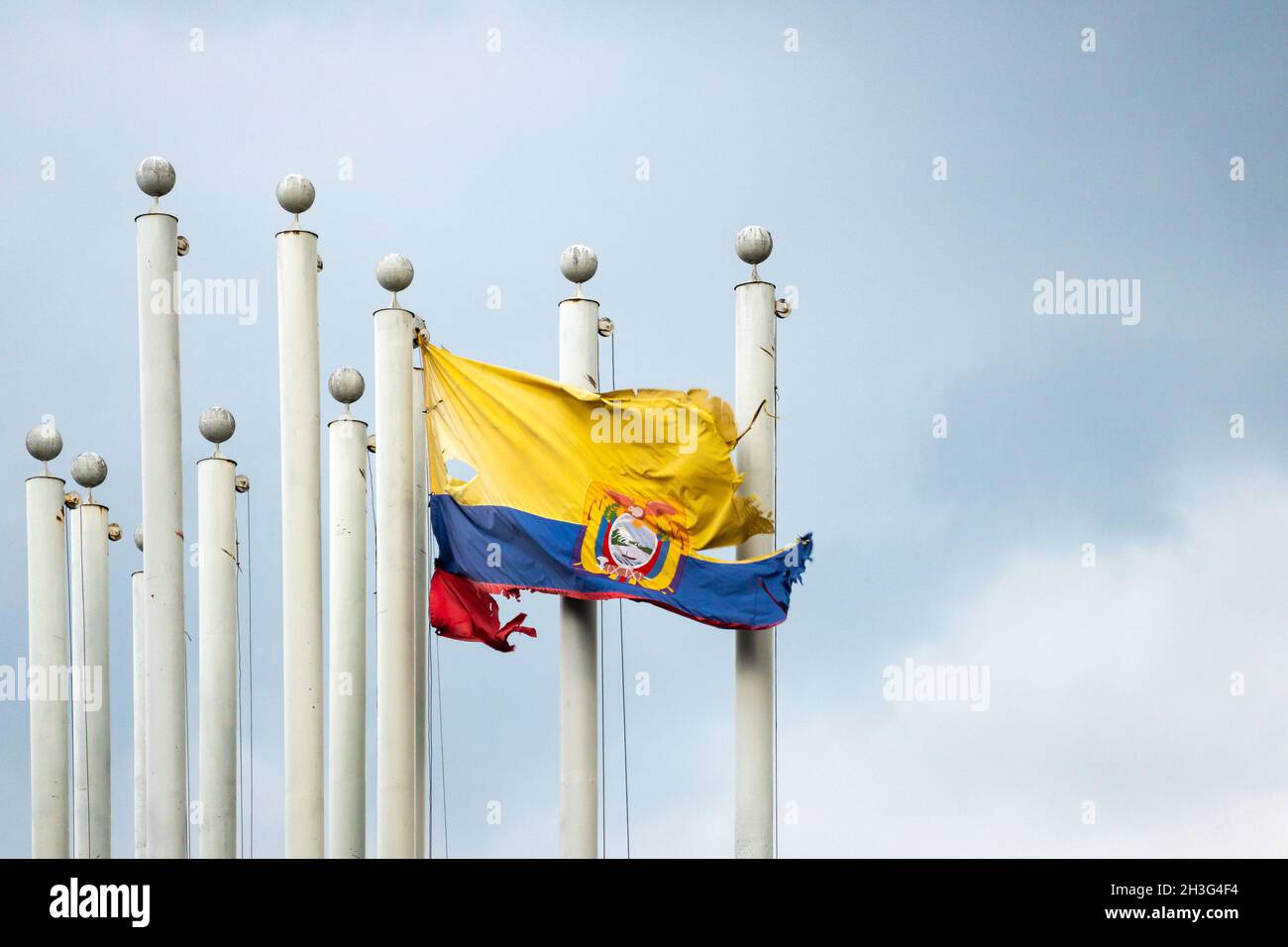 Old and Broken Flag of Colombia is Flying on a Flagpole Stock Photo