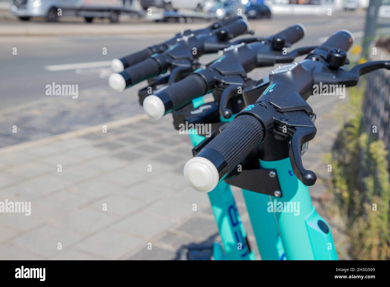 Electric scooter parked on the roadside green Steering wheel Stock Photo