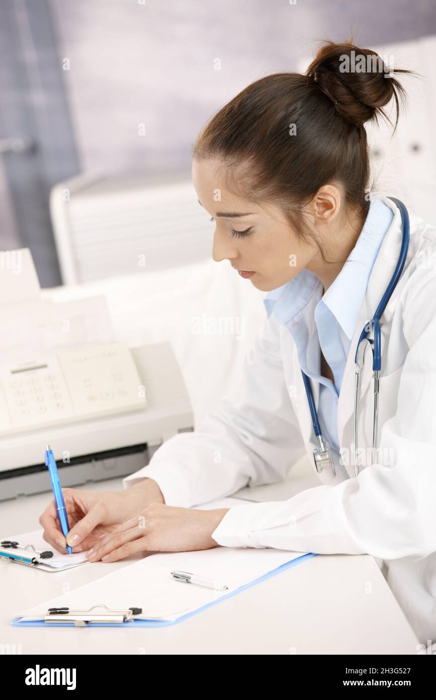 Professional female doctor writing hi-res stock photography and images ...