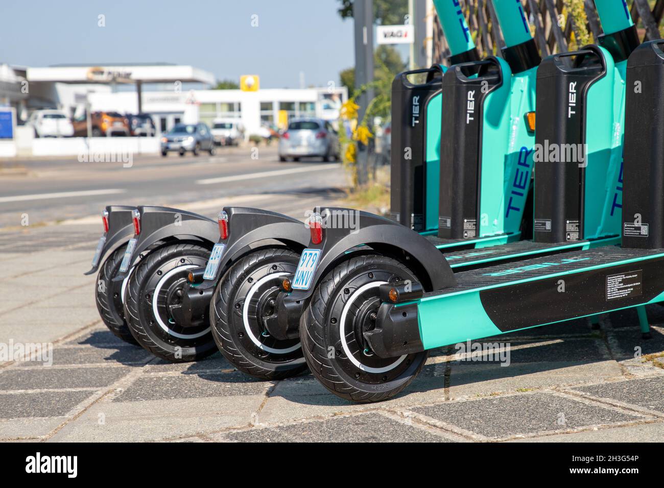Electric scooter parked on the roadside green wheel Stock Photo