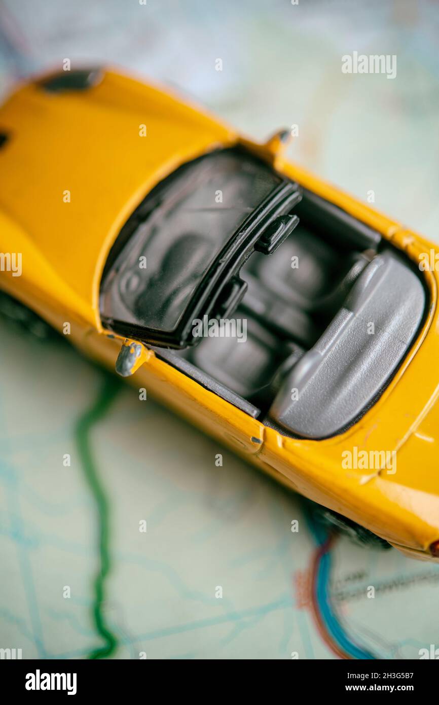 Toy car on a road map Stock Photo - Alamy