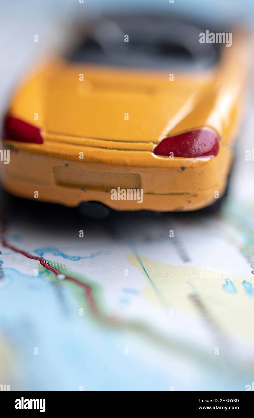 Toy car on a road map Stock Photo - Alamy