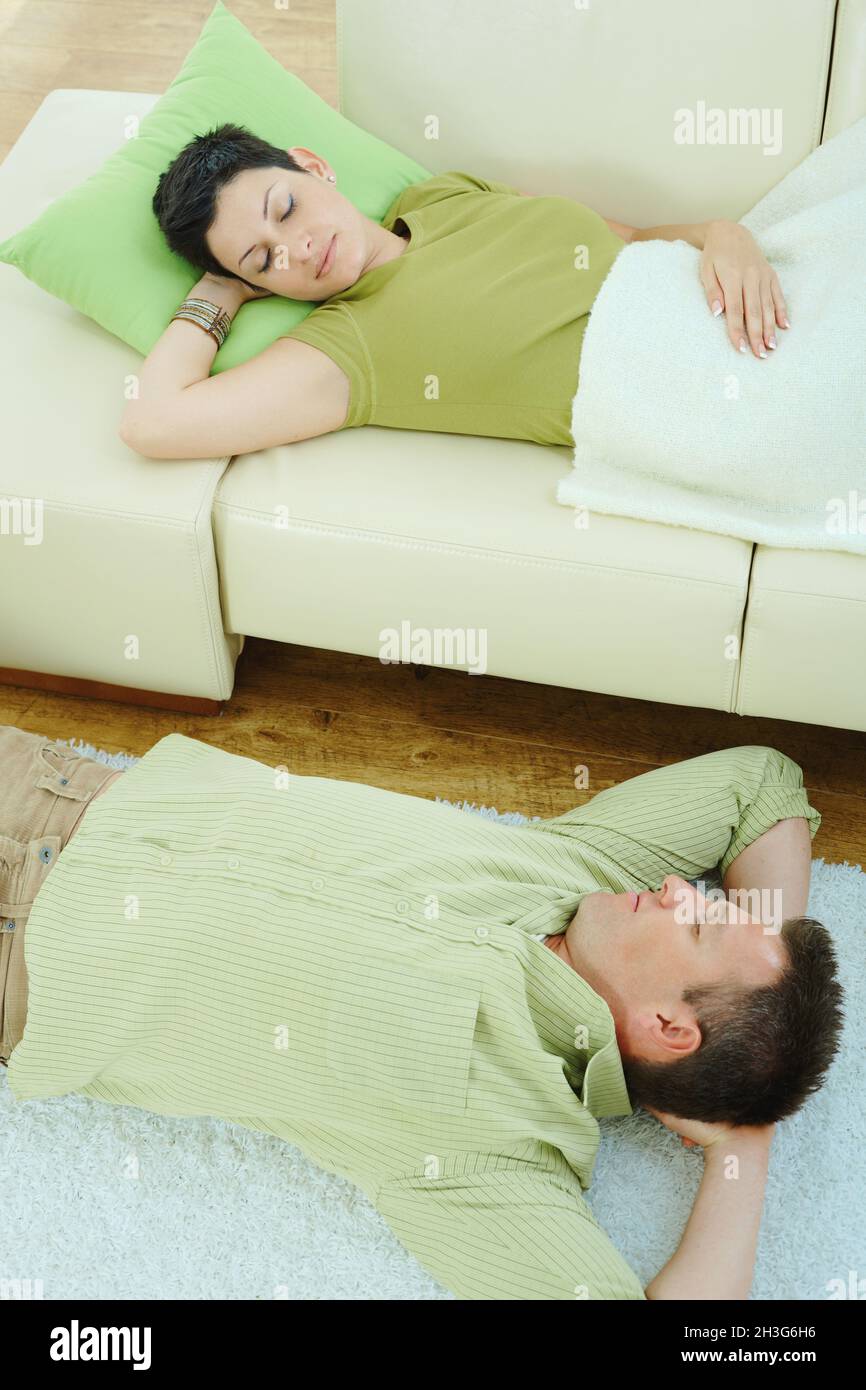 Couple sleeping on couch Stock Photo Alamy
