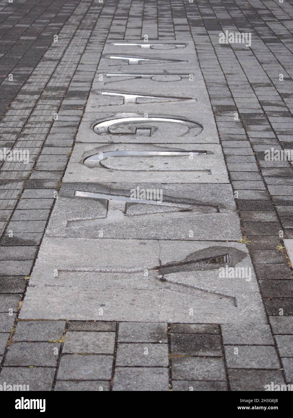 Paraguay, Country Name Written in Large Letters on a Wet Cement Floor in a Public Park Stock Photo