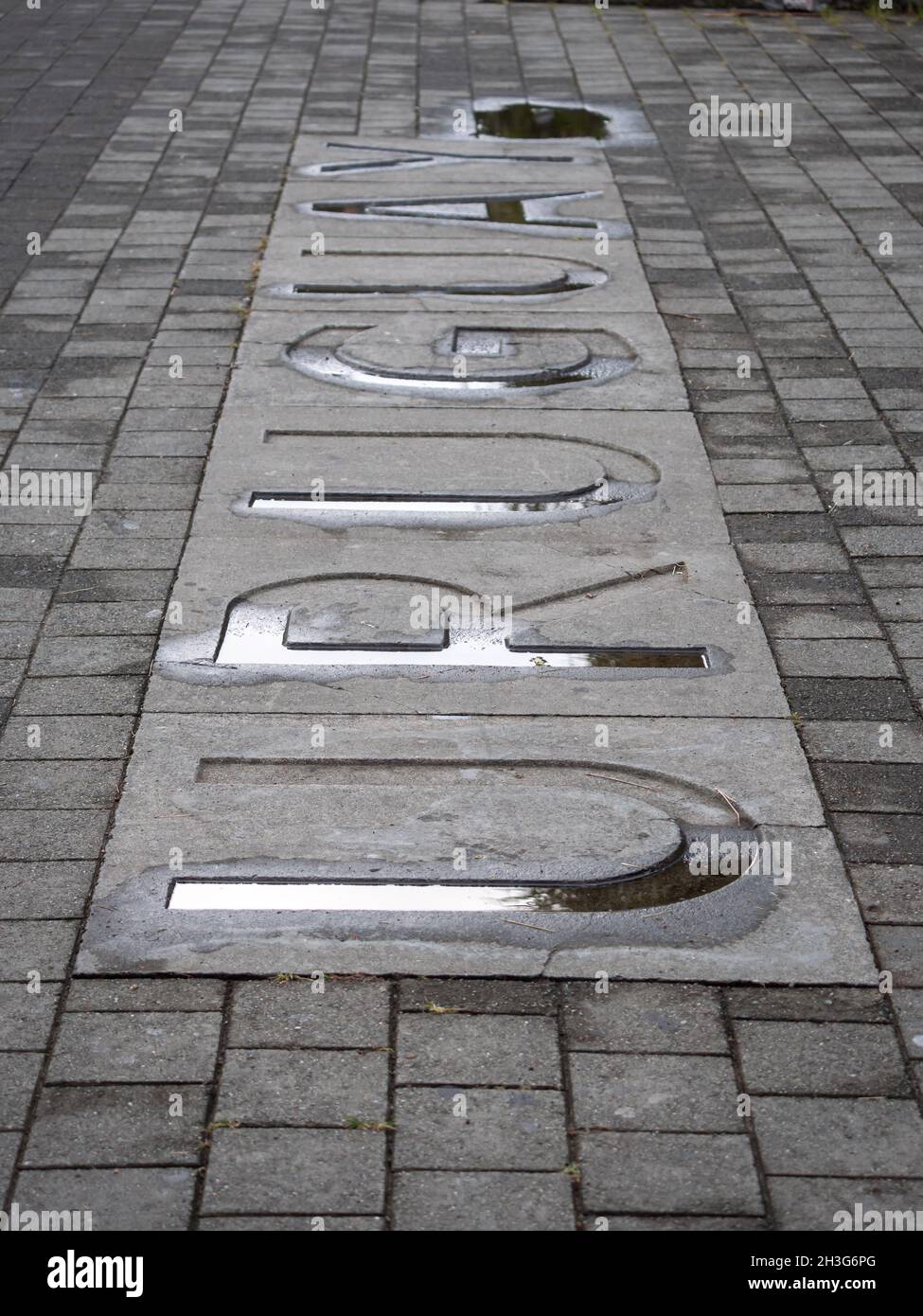 Uruguay, Country Name Written in Large Letters on a Wet Cement Floor in a Public Park Stock Photo