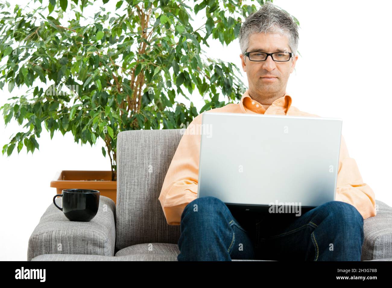 Man using laptop at home Stock Photo
