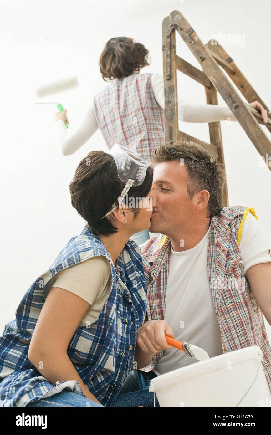Couple kissing while painting Stock Photo