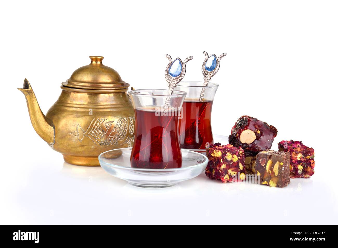 Traditional turkish delight rahat lokum with two glasses of tea and