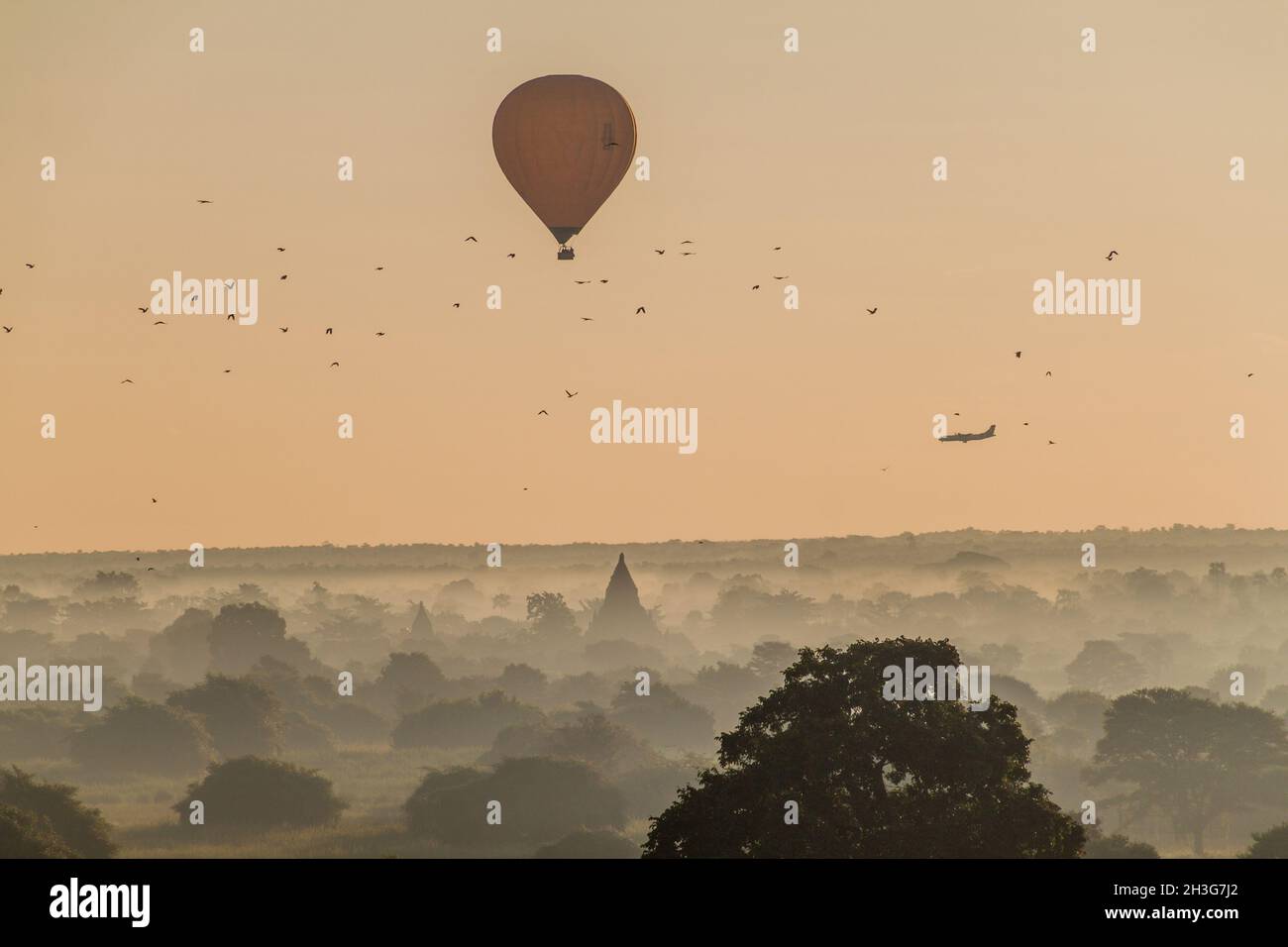 Balloon over Bagan, landing airplane and the skyline of its temples, Myanmar Stock Photo