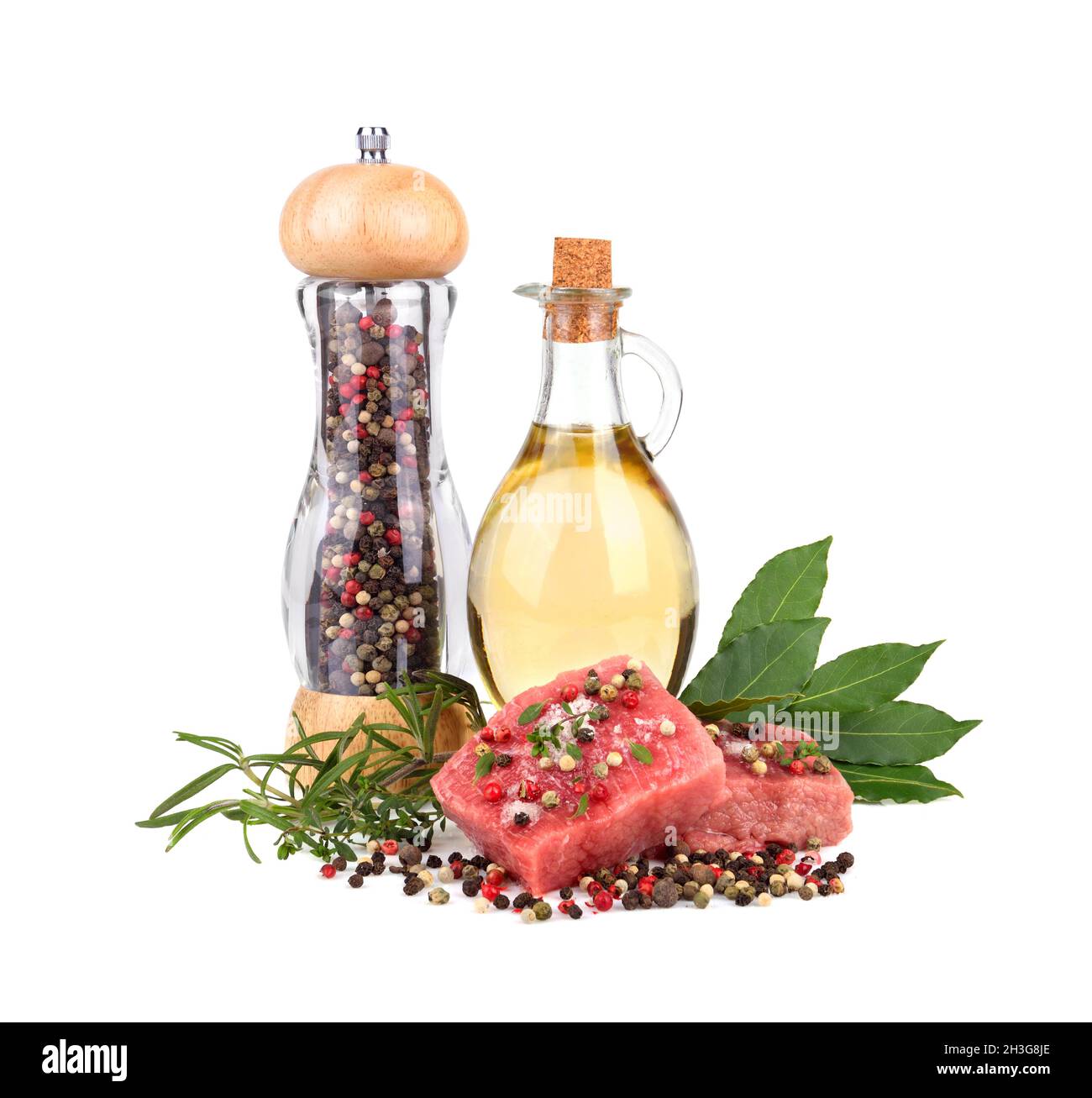 Fresh raw beef meat slices with bay leaves, olive oil and pepper mill