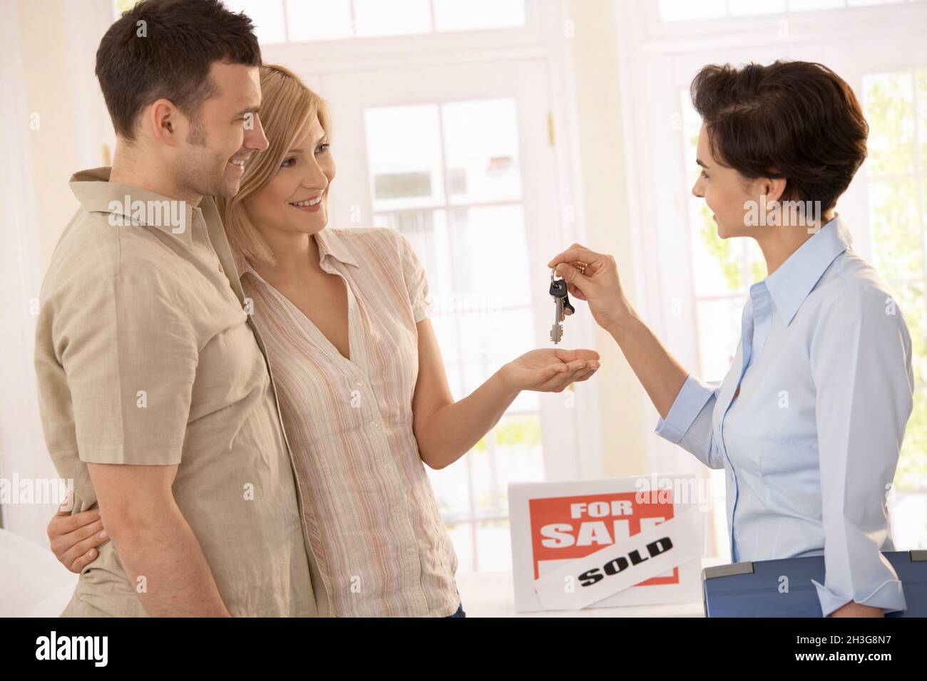 Estate agent handing over keys Stock Photo Alamy