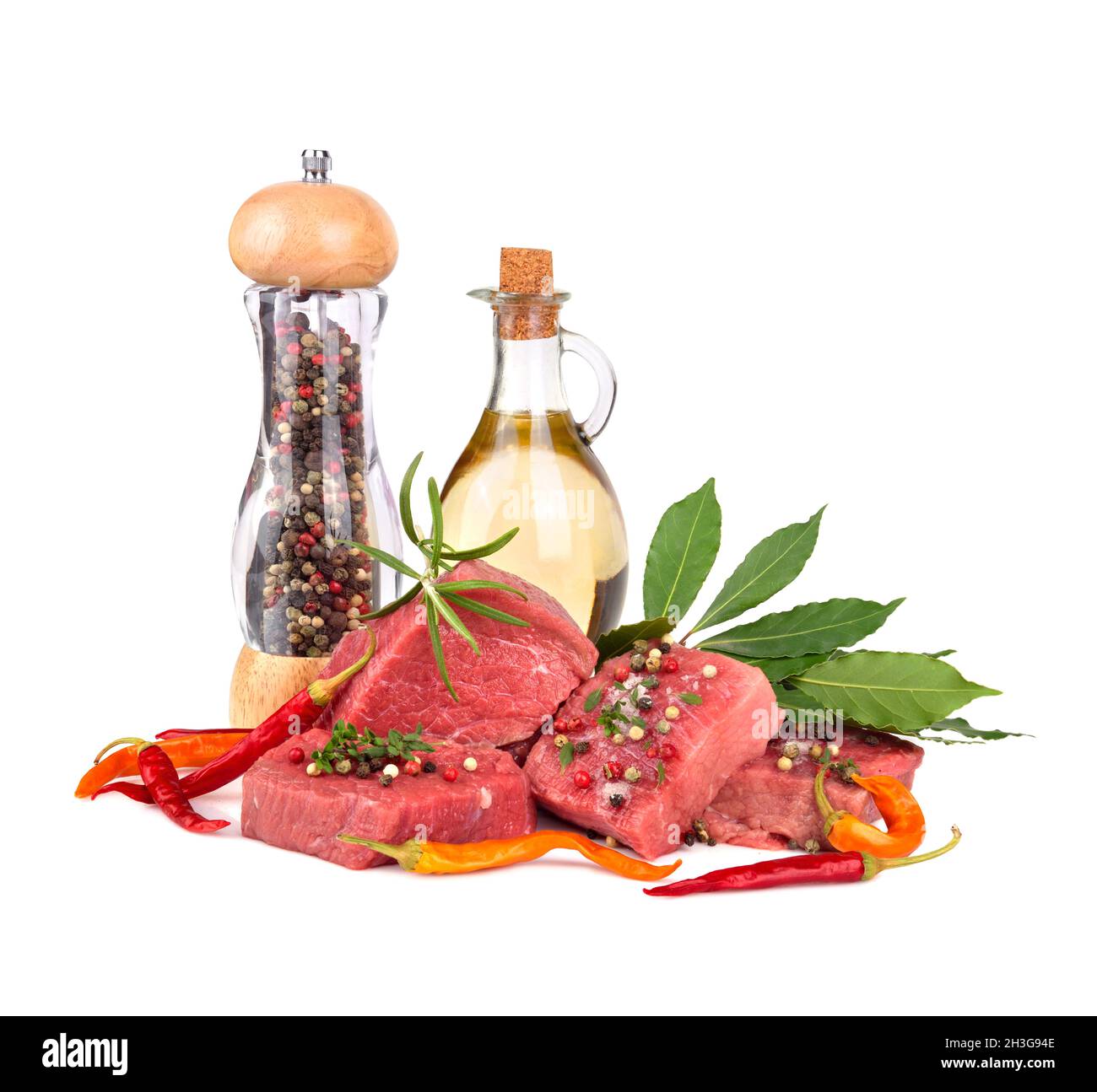 Fresh raw beef meat slices with bay leaves, olive oil and pepper mill
